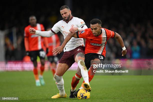 Kyle Walker of Manchester City battles for possession with Jacob Brown of Luton Town during the Premier League match between Luton Town and...