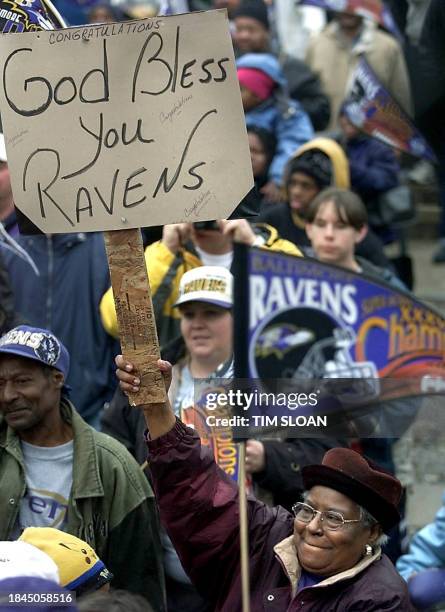 Woman holds a sign congratulating her Super Bowl XXXV champion Baltimore Ravens during a victory parade and celebration for the team and its fans in...