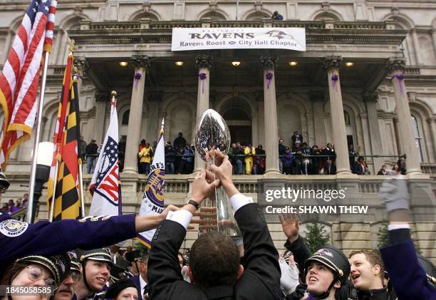 David Modell, son of Baltimore Ravens owner Art Modell, walks through the Ravens Marching Band to Baltimore City Hall with the Vince Lombardi Trophy...