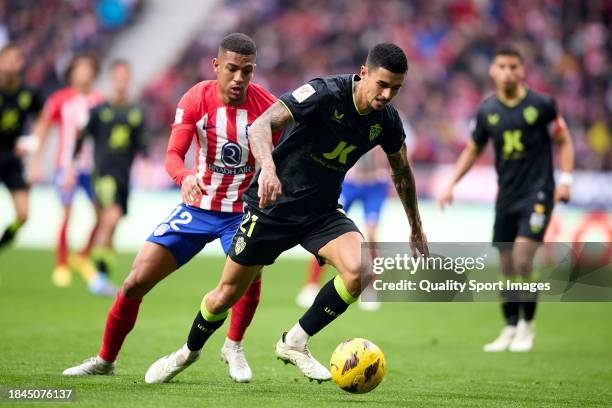 Chumi of UD Almeria runs with the ball under pressure from Samuel Lino of Atletico de Madrid during the LaLiga EA Sports match between Atletico...