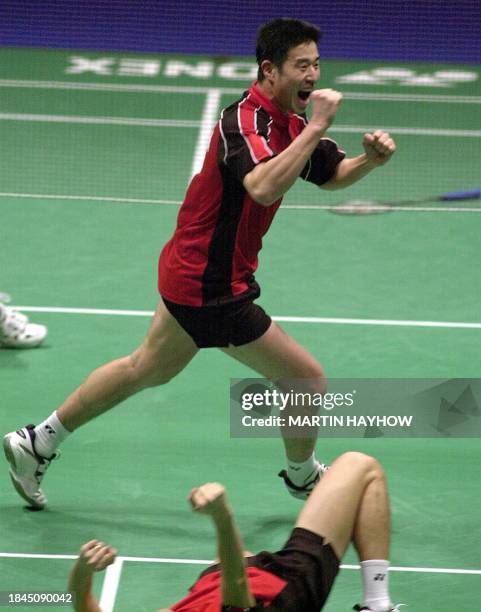 Ha Tae-Kwon of Korea jubilates as he runs past the prostrate body of his doubles partner Kim Dong-Moon 12 March 2000, after they had won the mens...