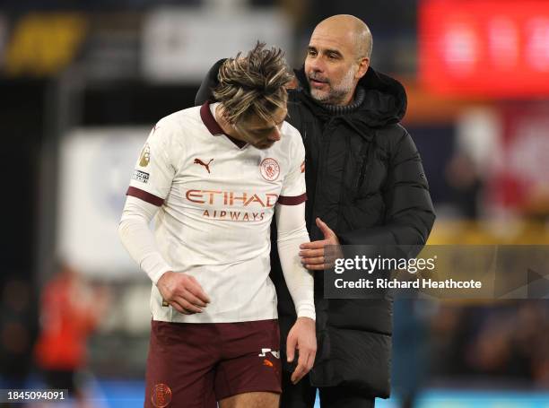Jack Grealish and Pep Guardiola, Manager of Manchester City, celebrate after the team's victory during the Premier League match between Luton Town...