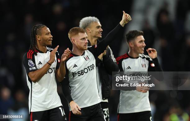 Bobby Reid and Harrison Reed of Fulham acknowledge the fans after the team's victory during the Premier League match between Fulham FC and West Ham...