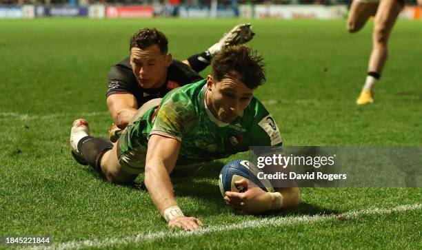 Josh Bassett of Leicester Tigers dives in to score their last minute, bonus point fourth try, during the Investec Champions Cup match between...