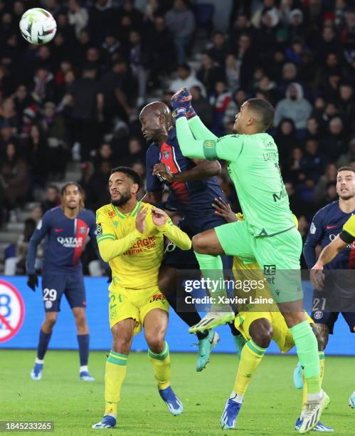 Alban Lafont of FC Nantes boxe the ball over Danilo Pereira of Paris Saint-Germain during the Ligue 1 Uber Eats match between Paris Saint-Germain and...