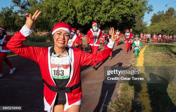 People participate in the 'Run Santa Run 2023' on December 10, 2023 in Zapopan, Mexico.