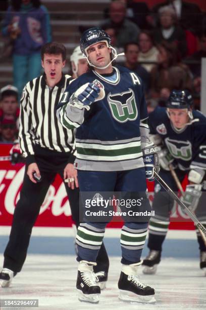 Hartford Whalers forward, John Cullen, talking with his bench as Linesman Pat DaPuzzo calls for the faceoff during the game against the NJ Devils at...