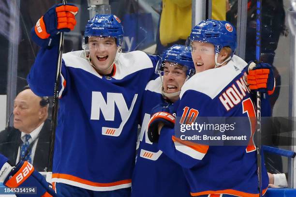 Noah Dobson, Jean-Gabariel Pageau and Simon Holmstrom of the New York Islanders celebrate Pageau's overtime goal against the Los Angeles Kings at UBS...