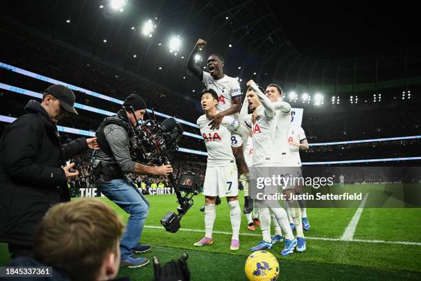 Son Heung-Min of Tottenham Hotspur celebrates with teammates after scoring their team's fourth goal from the penalty spot during the Premier League...