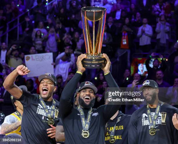 Rui Hachimura, LeBron James and Anthony Davis of the Los Angeles Lakers celebrate with the trophy after the team's 123-109 victory over the Indiana...