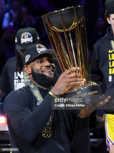 LeBron James of the Los Angeles Lakers lifts the trophy after the team's 123-109 victory over the Indiana Pacers to win the championship game of the...