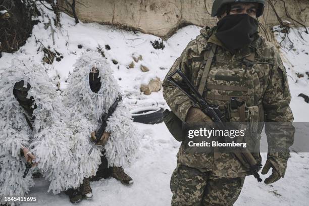 Members of the Siberian Battalion in snow camouflage during military exercises with the International Legion of the Armed Forces of Ukraine at an...