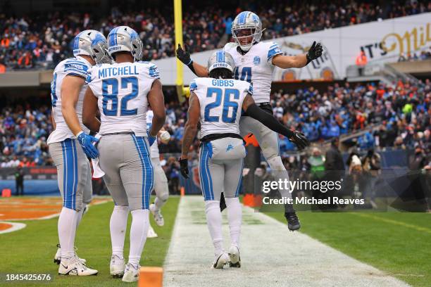 Jahmyr Gibbs of the Detroit Lions celebrates after a touchdown with Amon-Ra St. Brown during the second quarter in the game against the Chicago Bears...