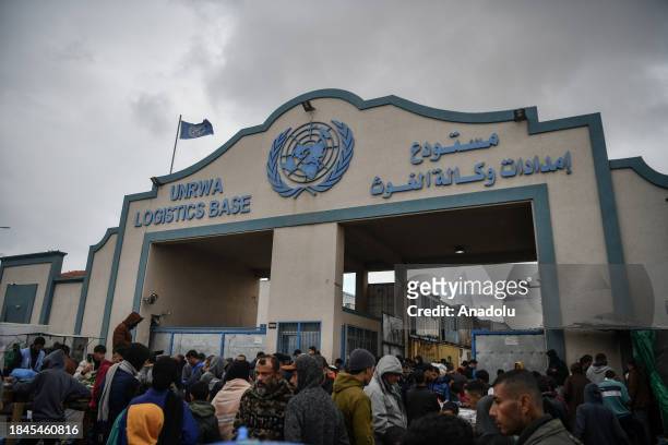 Palestinian families take refuge in the logistics base of UNRWA and in the makeshift tents they have built around the storage as they struggle with...