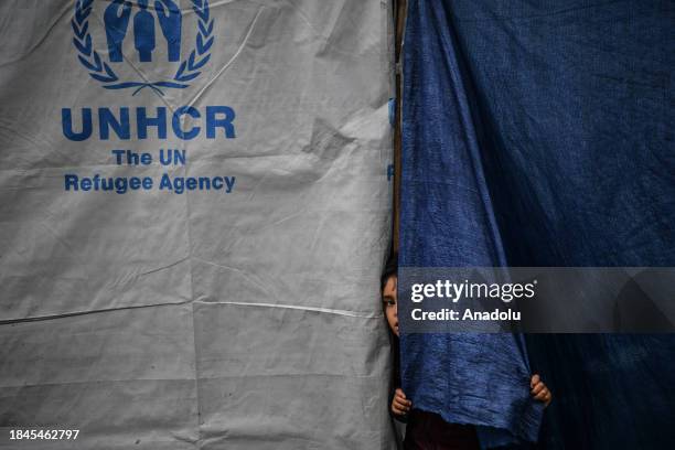 Palestinian families take refuge in the logistics base of UNRWA and in the makeshift tents they have built around the storage as they struggle with...