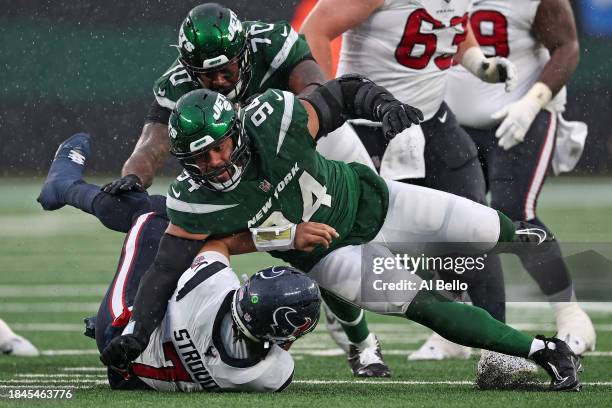 Solomon Thomas of the New York Jets sacks C.J. Stroud of the Houston Texans during the second quarter at MetLife Stadium on December 10, 2023 in East...