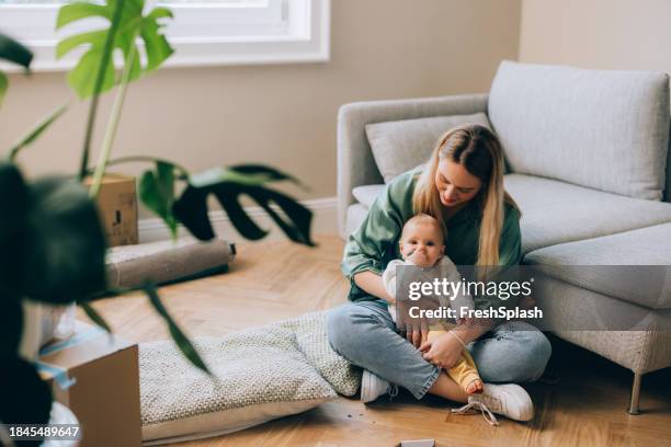 nesting with love: mom and baby move in - green sofa stock pictures, royalty-free photos & images