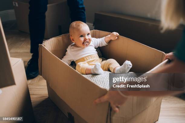 box of joy: baby's moving adventure - baby stockfoto's en -beelden