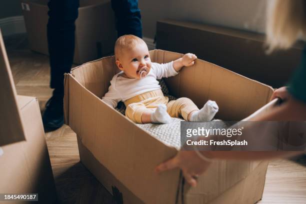 box of joy: baby's moving adventure - baby arrival stock pictures, royalty-free photos & images