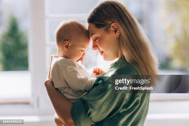 embracing motherhood: mother and baby share a moment of love - baby imagens e fotografias de stock