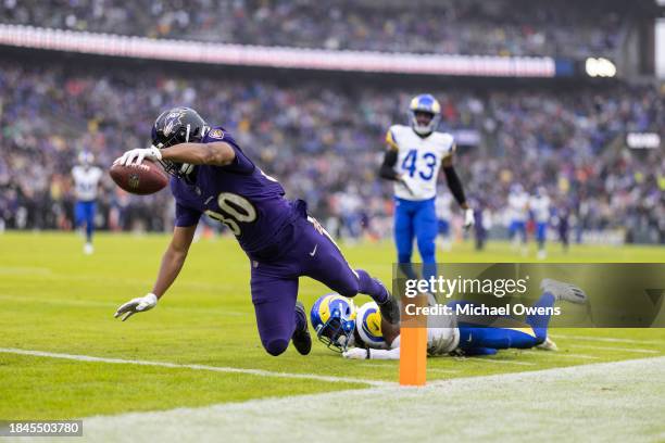 Isaiah Likely of the Baltimore Ravens dives and scores a touchdown during an NFL football game between the Baltimore Ravens and the Los Angeles Rams...