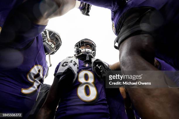 Lamar Jackson of the Baltimore Ravens looks on during a huddle prior to an NFL football game between the Baltimore Ravens and the Los Angeles Rams at...