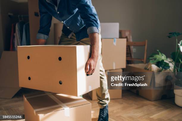 solo move-in: man unpacking boxes - offloading stock pictures, royalty-free photos & images