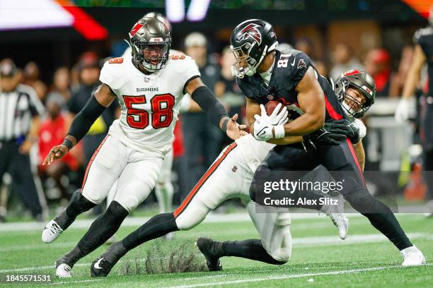 Anthony Nelson of the Tampa Bay Buccaneers tackles Jonnu Smith of the Atlanta Falcons during the second half of the game at Mercedes-Benz Stadium on...