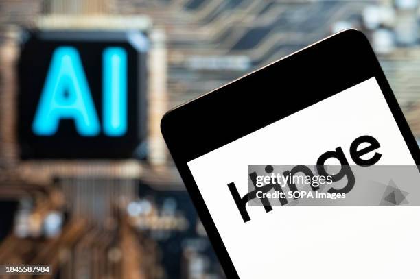 In this photo illustration, the online dating app Hinge logo seen displayed on a smartphone with an Artificial intelligence chip and symbol in the...