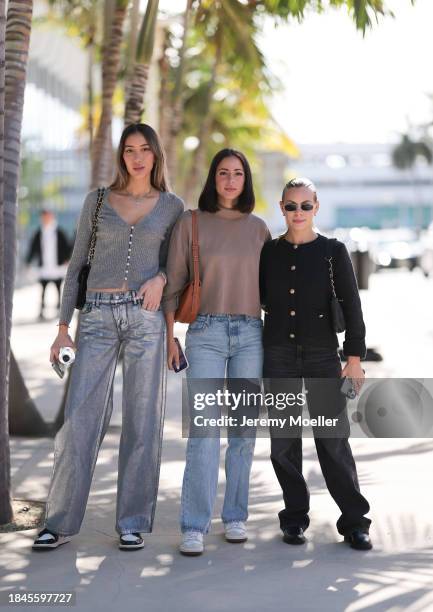 Jacqueline Sposito seen wearing gold necklaces, grey wool knit cardigan jacket, silver metallic-look denim jeans / pants, Chanel black leather...