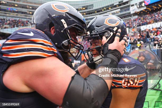 Justin Fields of the Chicago Bears celebrates after a touchdown with Lucas Patrick during the fourth quarter in the game against the Detroit Lions at...