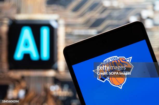 In this photo illustration, the American professional basketball NBA team The New York Knicks logo seen displayed on a smartphone with an Artificial...