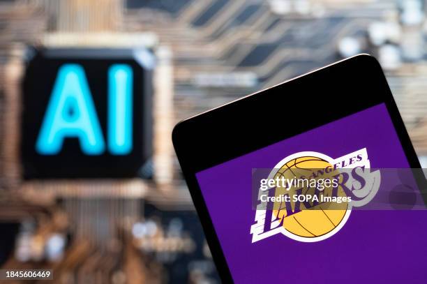 In this photo illustration, the American professional basketball NBA team The Los Angeles Lakers team logo seen displayed on a smartphone with an...