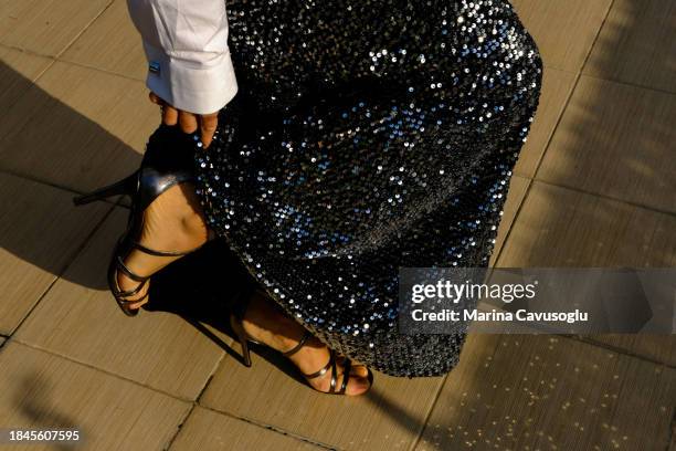 woman wearing party dress made of glowing festive sequined fabric. new year's eve celebration. - glitter dress stock-fotos und bilder