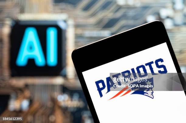 In this photo illustration, the American professional NFL football team the New England Patriots logo seen displayed on a smartphone with an...