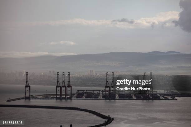 Cargo ships are seen at Israel's Haifa commercial shipping port in the Mediterranean Sea on December 13, 2023. In solidarity with Palestinians in...