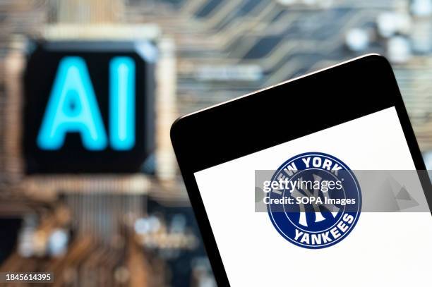 In this photo illustration, the American professional Major baseball team league the New York Yankees logo seen displayed on a smartphone with an...