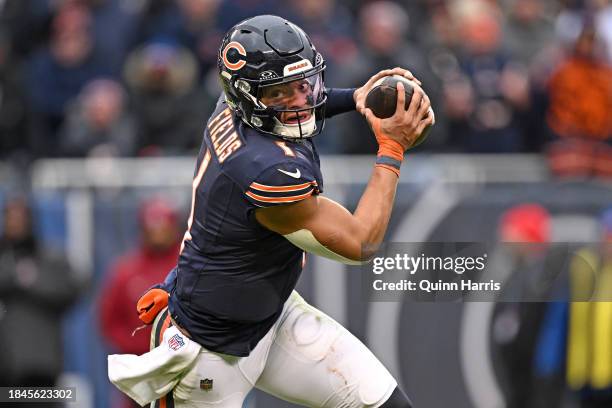 Justin Fields of the Chicago Bears scrambles during the second half in the game against the Detroit Lions at Soldier Field on December 10, 2023 in...