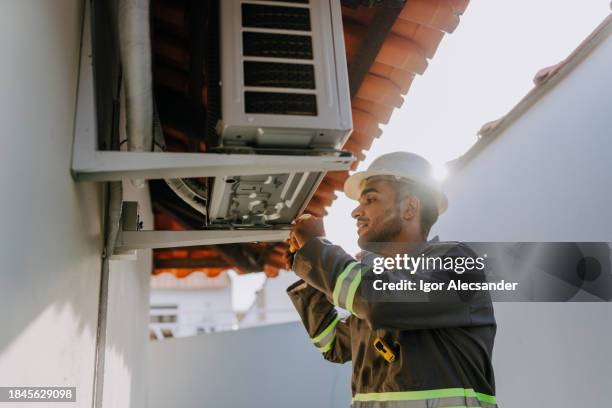 technician checking air conditioning unit - vvs bildbanksfoton och bilder