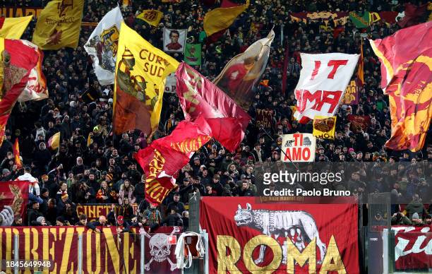 Fans of AS Roma show their support as they wave flags during the Serie A TIM match between AS Roma and ACF Fiorentina at Stadio Olimpico on December...