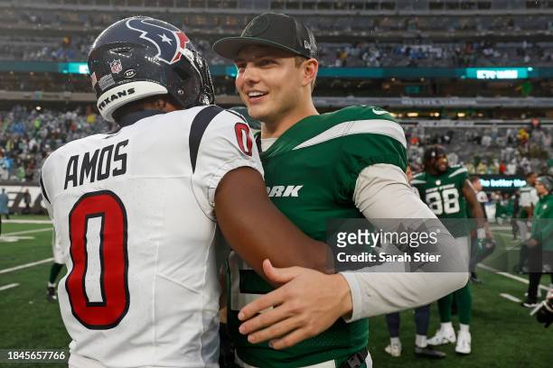 Zach Wilson of the New York Jets and Adrian Amos of the Houston Texans embrace after the game at MetLife Stadium on December 10, 2023 in East...