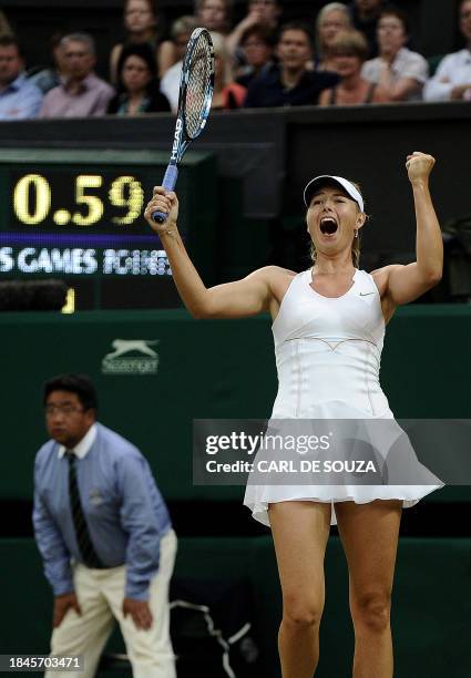 Russian player Maria Sharapova reacts after beating Slovak player Dominika Cibulkova during the women's guarter final at the Wimbledon Tennis...