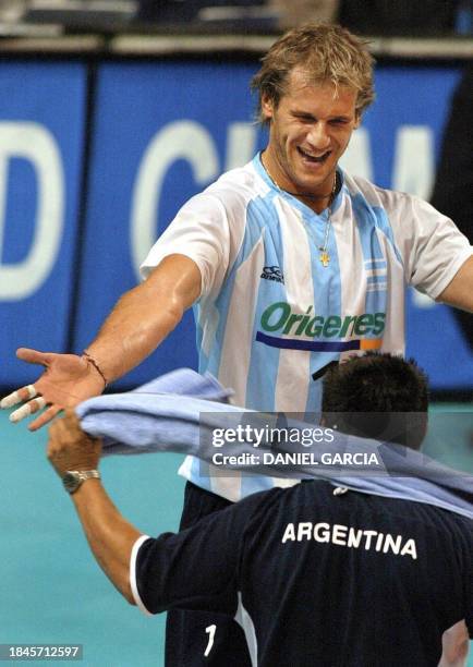 Argentinian Marcos Milinkovic celebrates with an unidentified teammate after Argentina defeated Italy 3-1 for the Pool G-round match at the Men's...