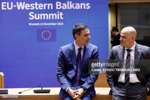 Prime Minister of Spain, Pedro Sanchez speaks with North Macedonia's Prime Minister, Dimitar Kovacevski as they arrive to attend a roundtable meeting...