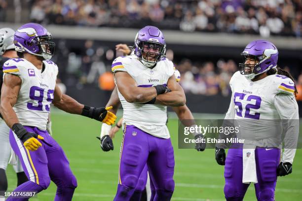 Linebackers Danielle Hunter and D.J. Wonnum and defensive tackle Sheldon Day of the Minnesota Vikings celebrate after Wonnum sacked quarterback Aidan...