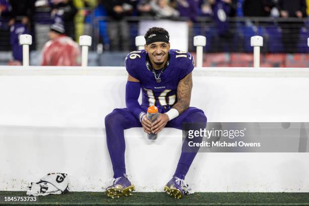 Tylan Wallace of the Baltimore Ravens reacts on the bench after returning a punt for a touchdown in overtime following an NFL football game between...