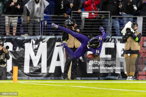 Tylan Wallace of the Baltimore Ravens dives into the end zone as he returns a punt for a touchdown in overtime during an NFL football game between...