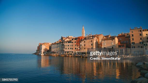 picturesque old town in rovinj by sea against clear blue sky at croatia - rovinj stock pictures, royalty-free photos & images