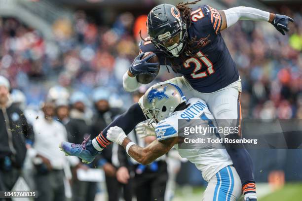 Running back D'Onta Foreman of the Chicago Bears leaps over cornerback Cameron Sutton of the Detroit Lions during an NFL football game at Soldier...