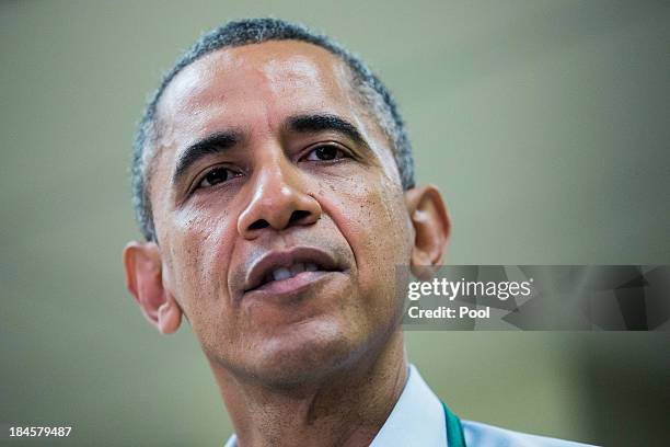 President Barack Obama speaks while visiting with furloughed federal workers, while they volunteer at a Martha's Table kitchen on October 14, 2013 in...